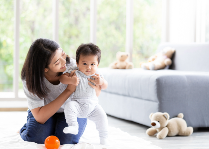 Woman and baby playing on the floor