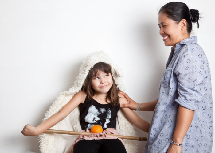 Care provider smiling down at a child